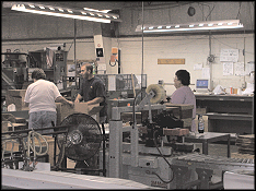 McNaughton and Gunn employees working on printing press