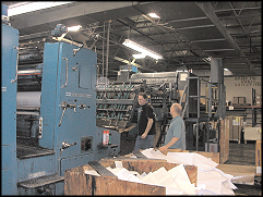 McNaughton and Gunn employees working on printing press